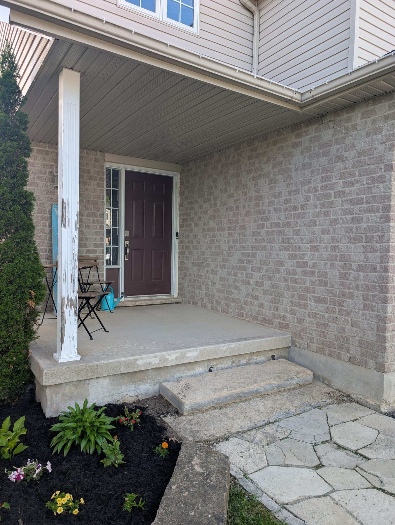 Before: cracked step and bare, patchy garden bed
